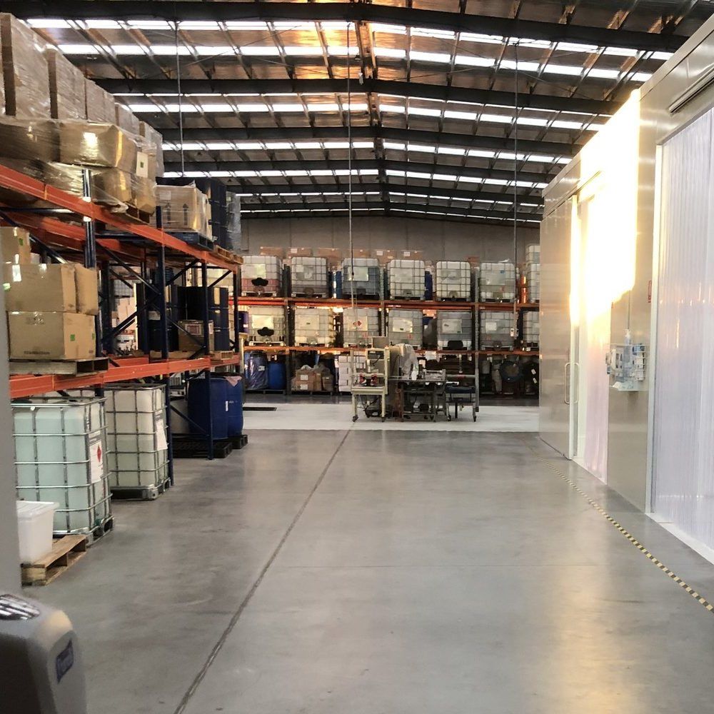 Aisle between pallet racking and a clean room wall on the manufacturing floor